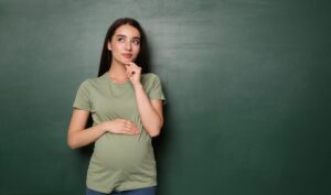 Pregnant woman standing in front of a blackboard | Gabriel Network